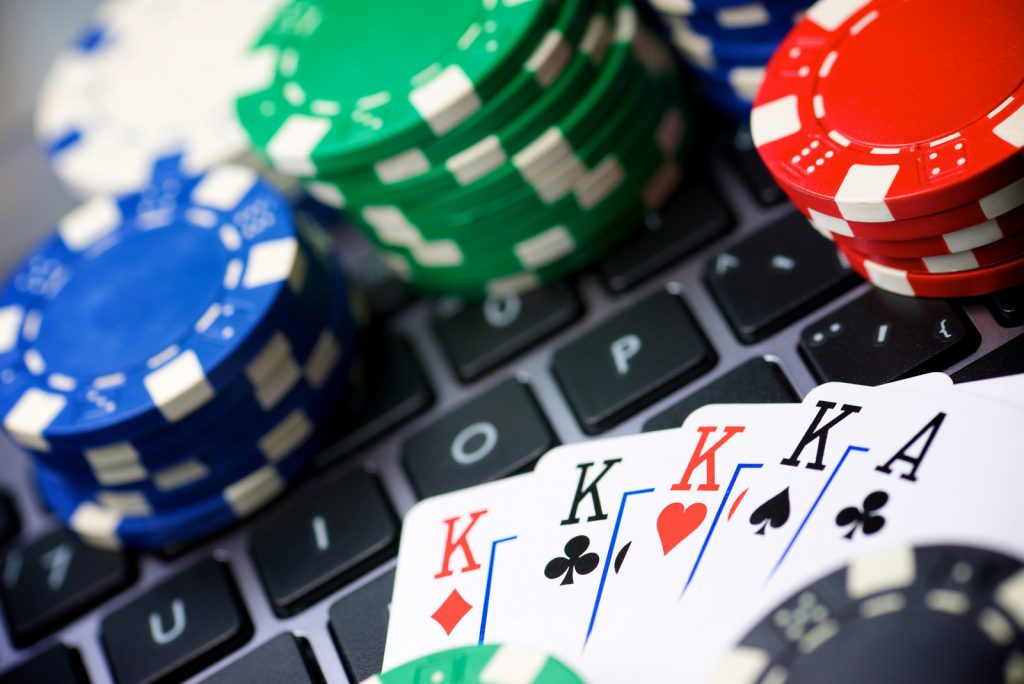 Casino chips and cards stacking on a laptop