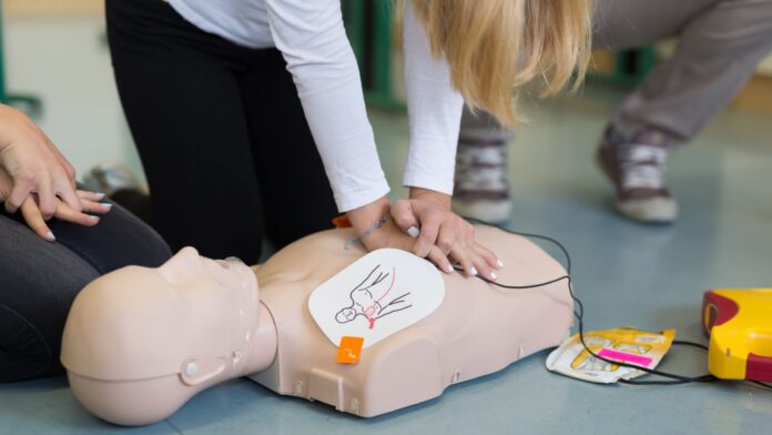 an aed has advised that a shock should be given. which of the following is appropriate?
